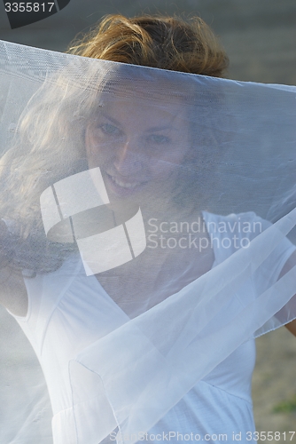 Image of Young pretty woman with white scarf