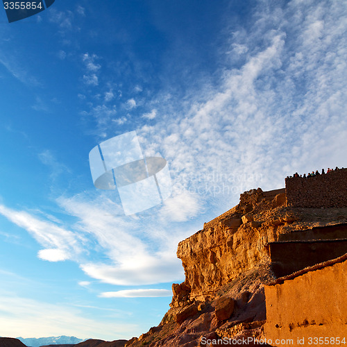 Image of sunset in africa old construction near       the river blue