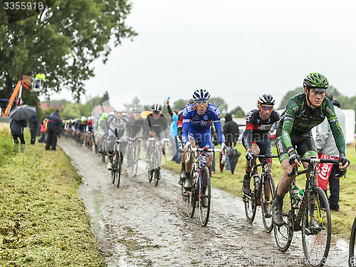 Image of The Peloton on a Cobbled Road- Tour de France 2014