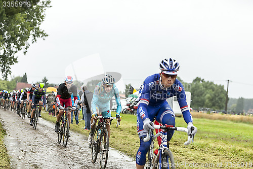 Image of The Peloton on a Cobbled Road- Tour de France 2014