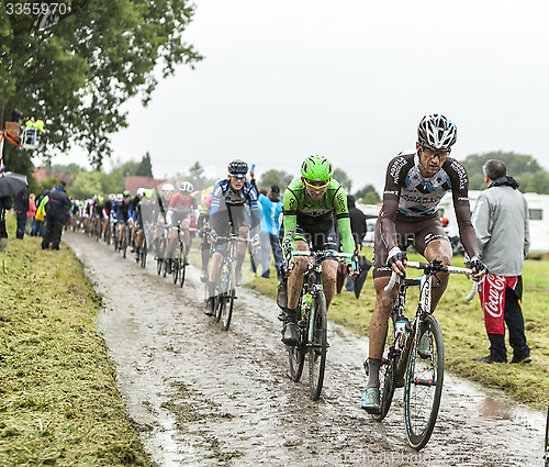 Image of The Peloton on a Cobbled Road- Tour de France 2014