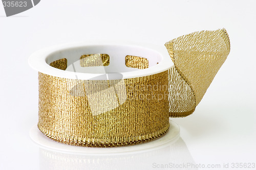 Image of A spool of golden girft wrapping ribbon