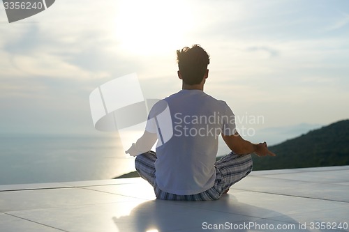 Image of young man practicing yoga