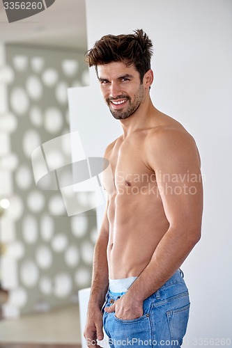 Image of shirtles handsome young man in jeans