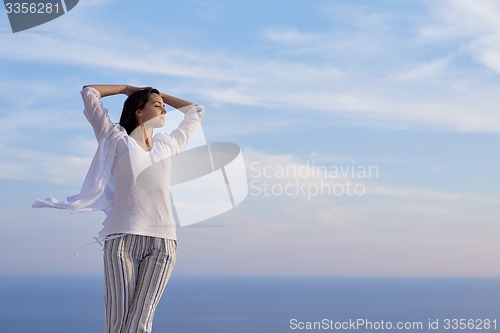 Image of young woman enjoy sunset