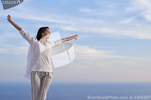 Image of young woman enjoy sunset