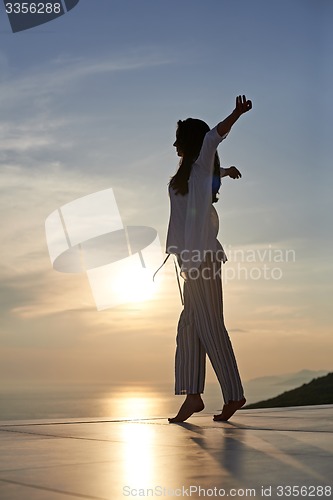 Image of young woman enjoy sunset