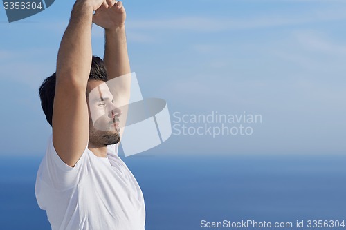 Image of young man practicing yoga