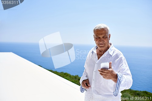 Image of senior man using smart phone