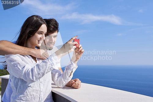 Image of young couple taking selfie with phone