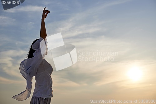 Image of young woman enjoy sunset