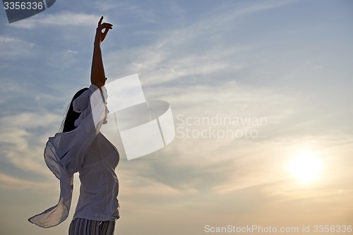 Image of young woman enjoy sunset