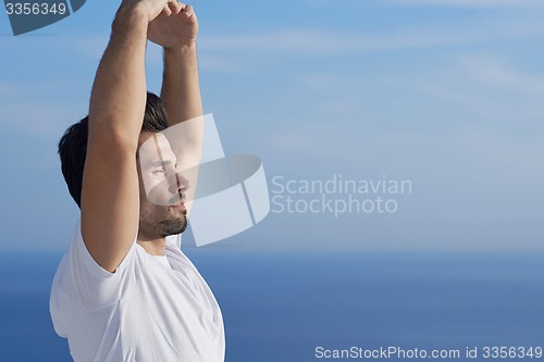 Image of young man practicing yoga