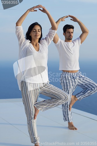 Image of young couple practicing yoga