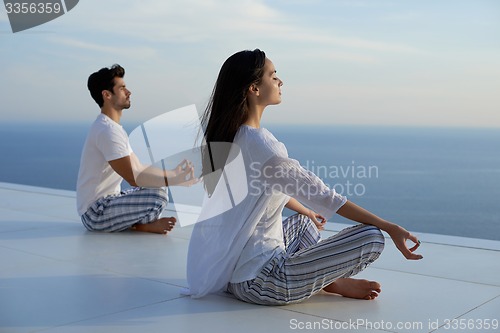 Image of young couple practicing yoga