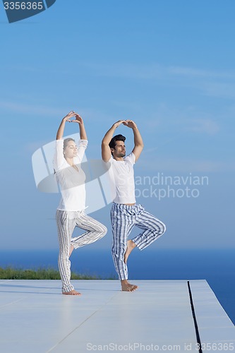 Image of young couple practicing yoga