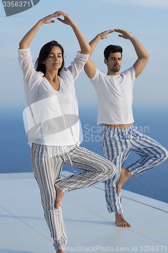 Image of young couple practicing yoga