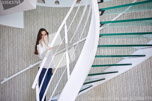 Image of woman walking on spiral stairs