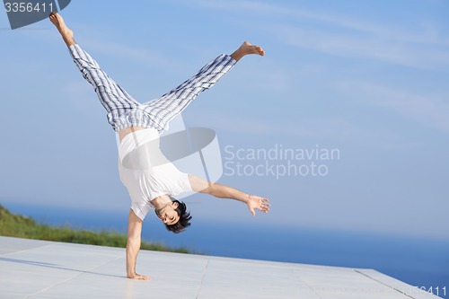 Image of young man practicing yoga