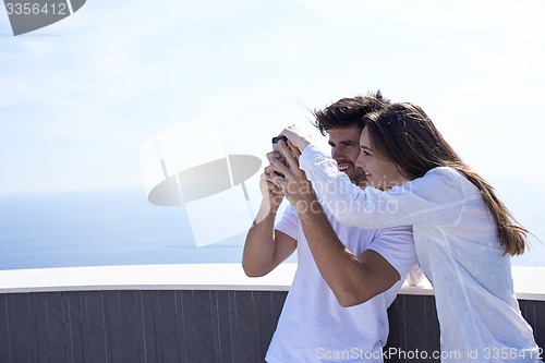 Image of young couple taking selfie with phone