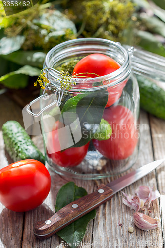 Image of Vegetables and herbs in the glass jar for home canning.