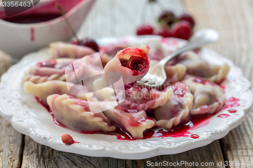 Image of Dumplings with a cherry.