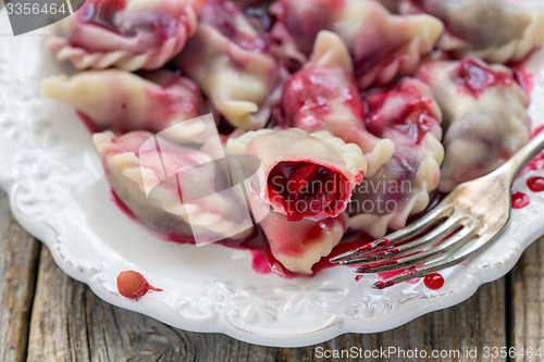 Image of Sweet dumplings with red cherry.