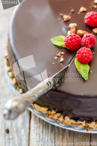 Image of Vintage knife cutting a chocolate cake.