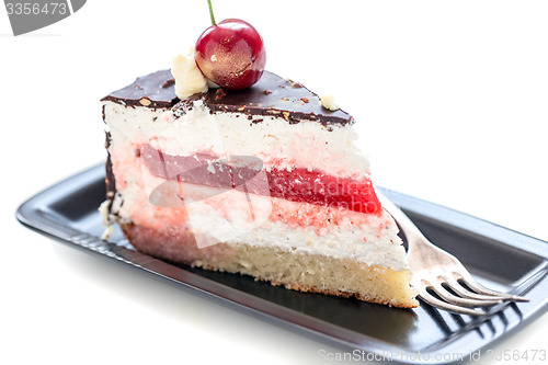 Image of Piece of chocolate cake with cherry and vanilla.