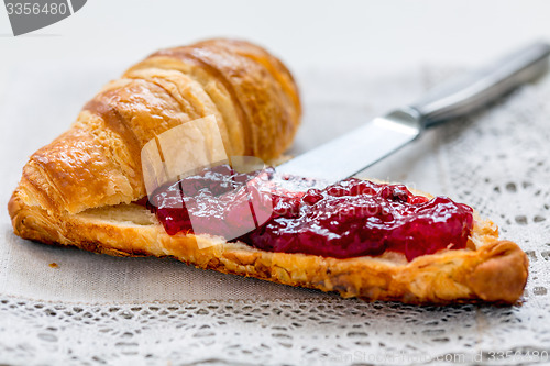 Image of Croissant with lingonberry jam.