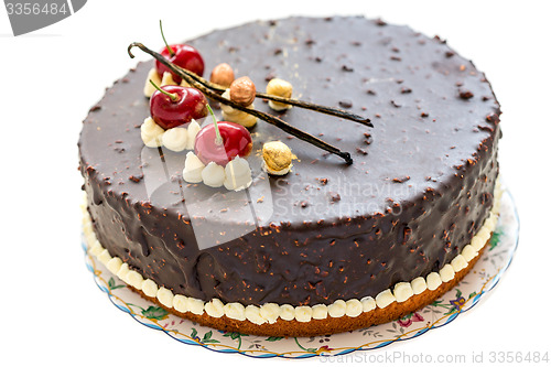Image of Cake with a cherry and vanilla.