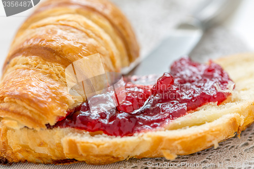 Image of Croissant with cranberry jam closeup.