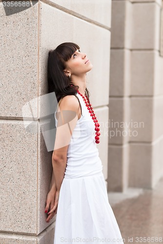 Image of Attractive sad girl with red beads
