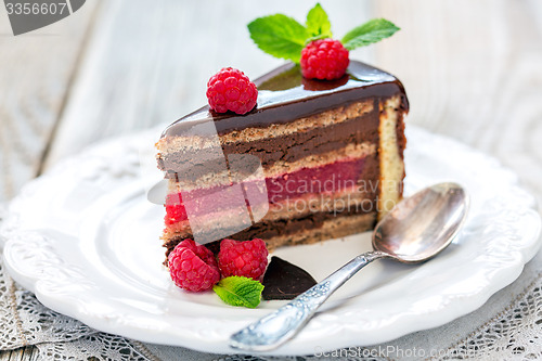 Image of Piece of chocolate cake with raspberry jelly.