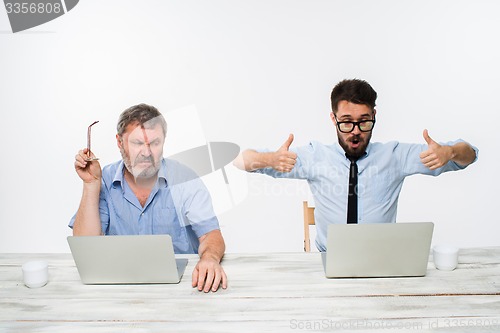 Image of The two colleagues working together at office on white background