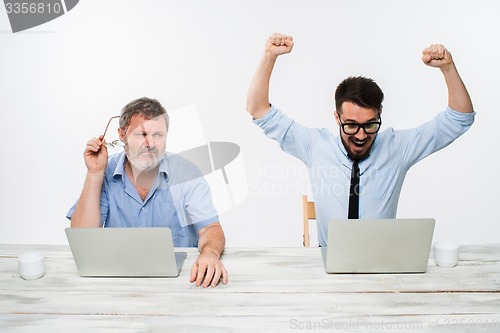 Image of The two colleagues working together at office on white background