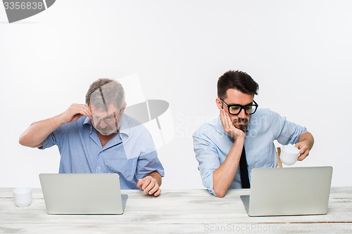 Image of The two colleagues working together at office on white background