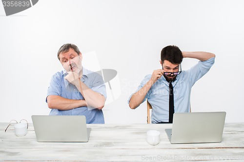 Image of The two colleagues working together at office on white background