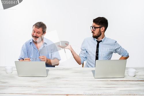 Image of The two colleagues working together at office on white background