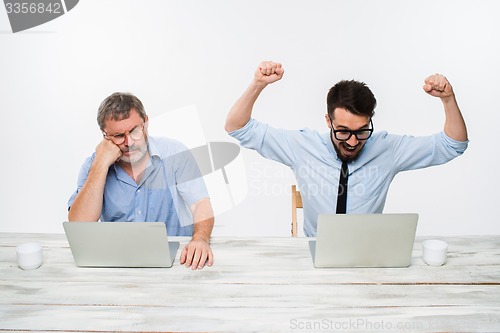 Image of The two colleagues working together at office on white background