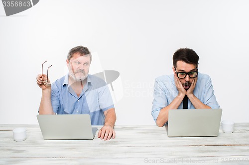 Image of The two colleagues working together at office on white background