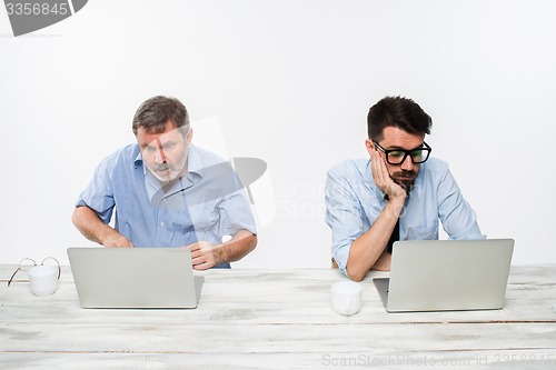 Image of The two colleagues working together at office on white background