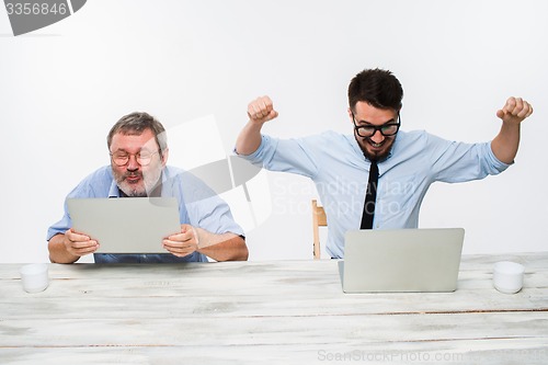 Image of The two colleagues working together at office on white background