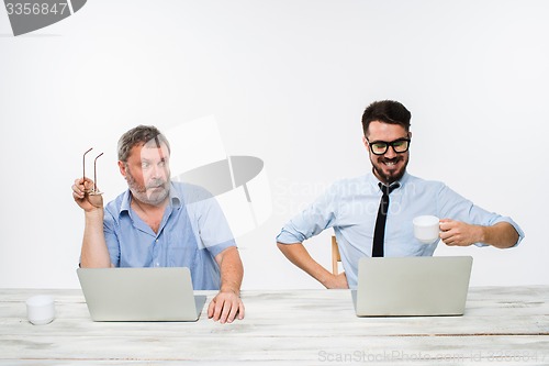 Image of The two colleagues working together at office on white background