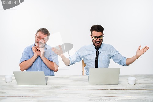 Image of The two colleagues working together at office on white background