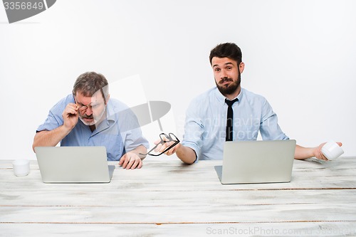 Image of The two colleagues working together at office on white background