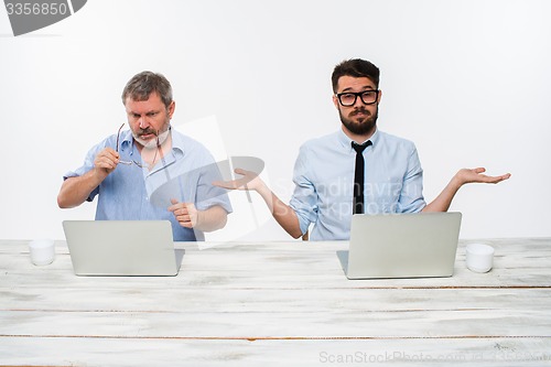 Image of The two colleagues working together at office on white background