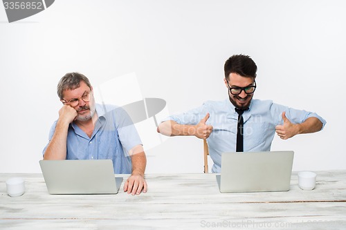 Image of The two colleagues working together at office on white background