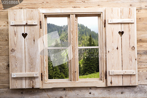 Image of Wooden window with mountain reflections