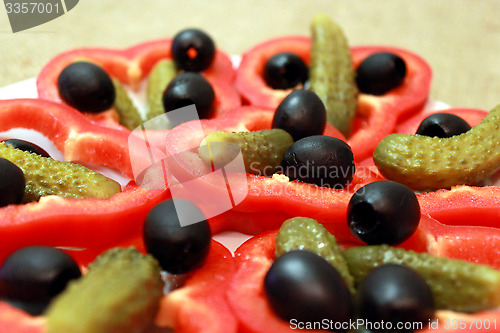 Image of Black olives, marinaded cucumbers and paprika